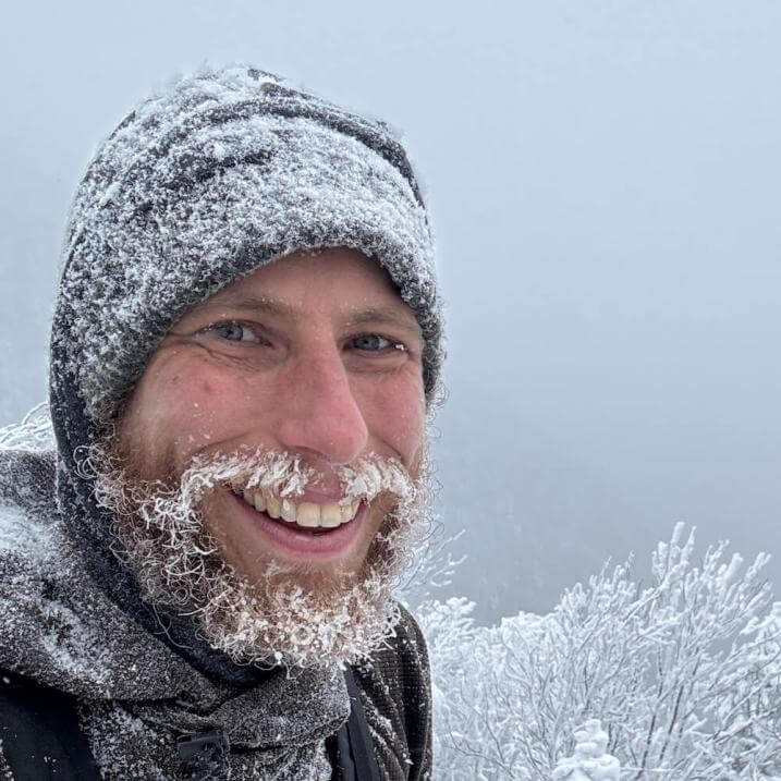 A snowy Jason whose beard and mustache are covered in frost.