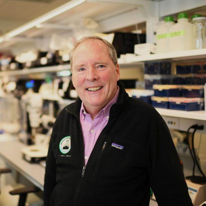 Person smiling posed in a lab