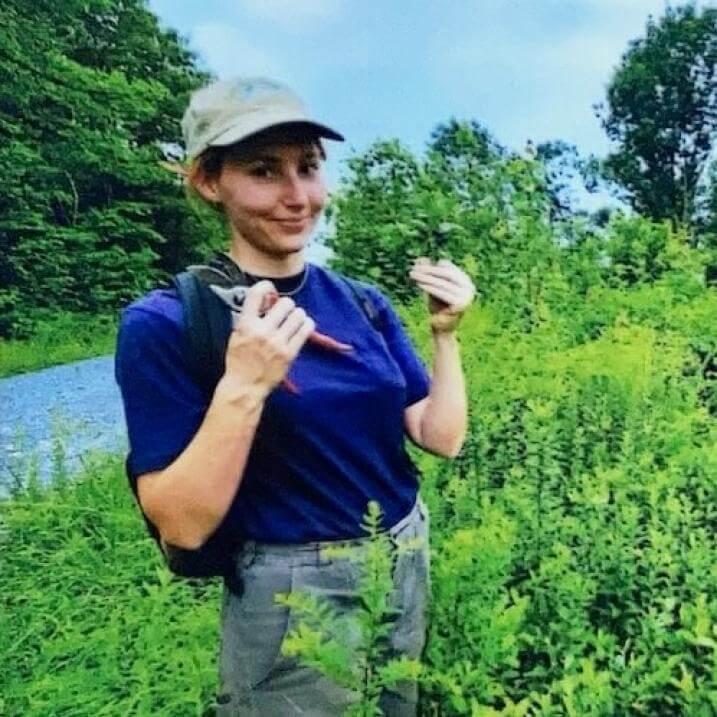 Veronica taking plant cuttings in the field