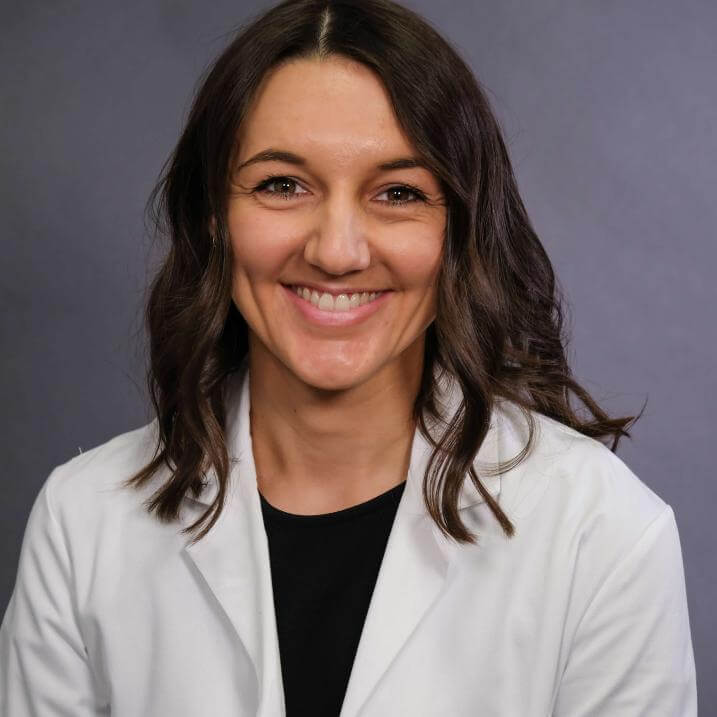 A person wearing a white coat