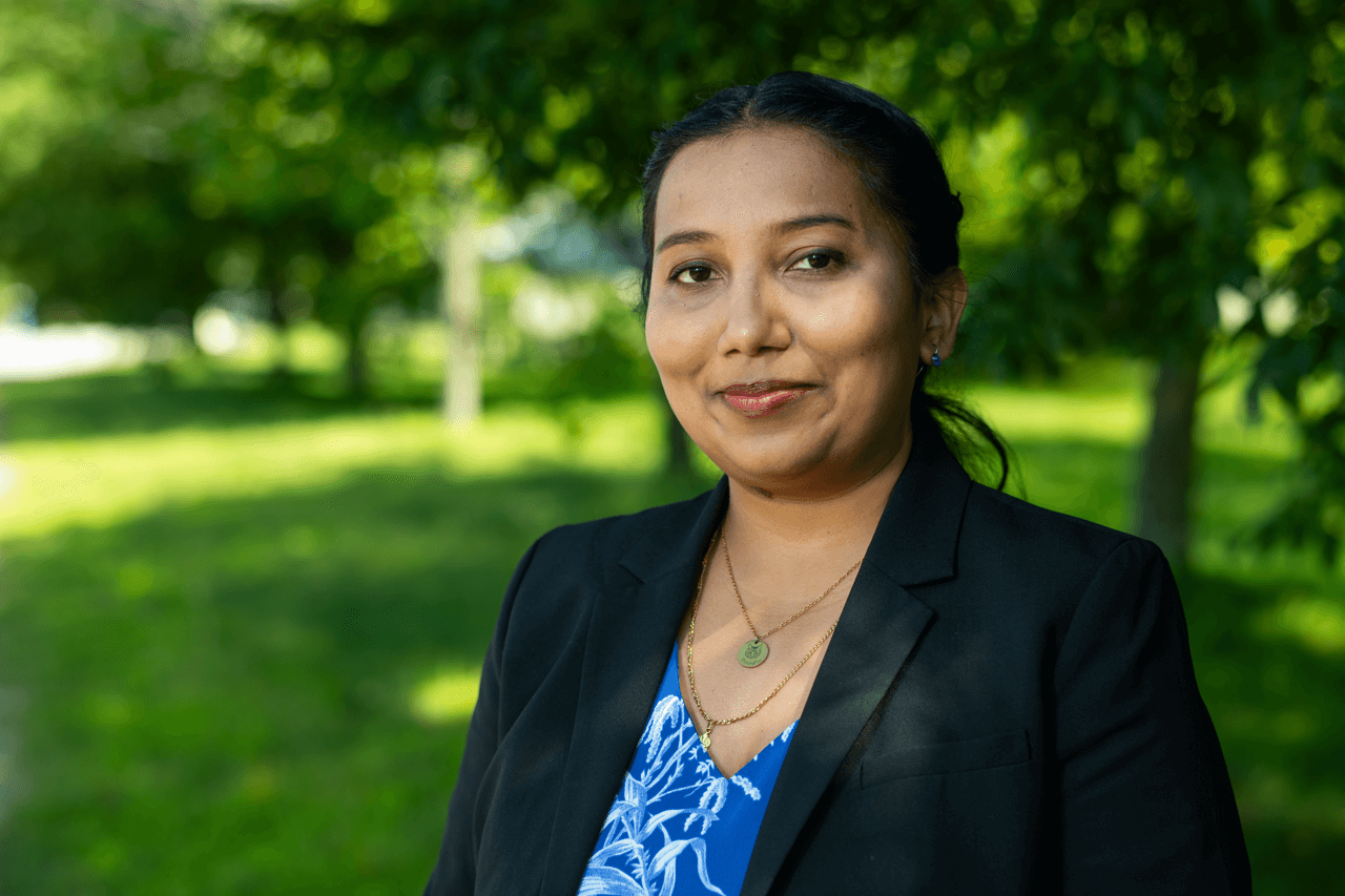 Photo of Faculty Trishnee Bhurosy with grass and trees behind
