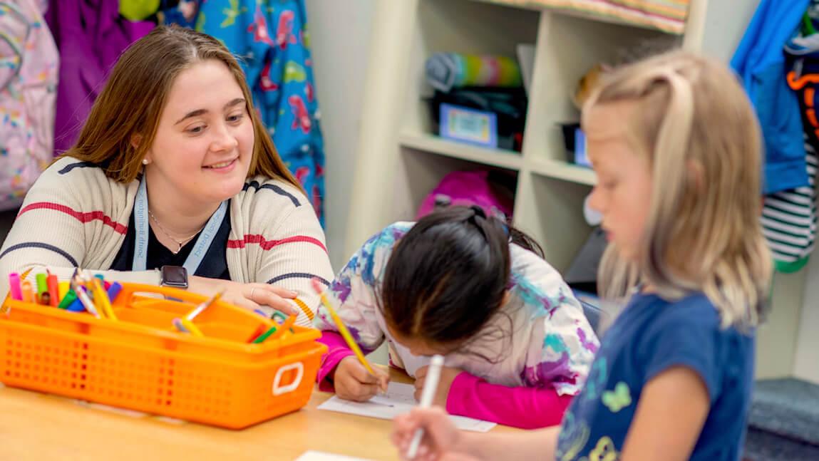Sarah Bassett works with students at Orchard Elementary School