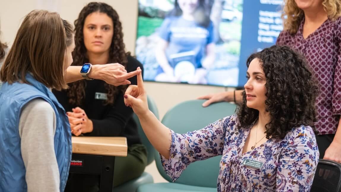 UVM OT students with a client in the lab