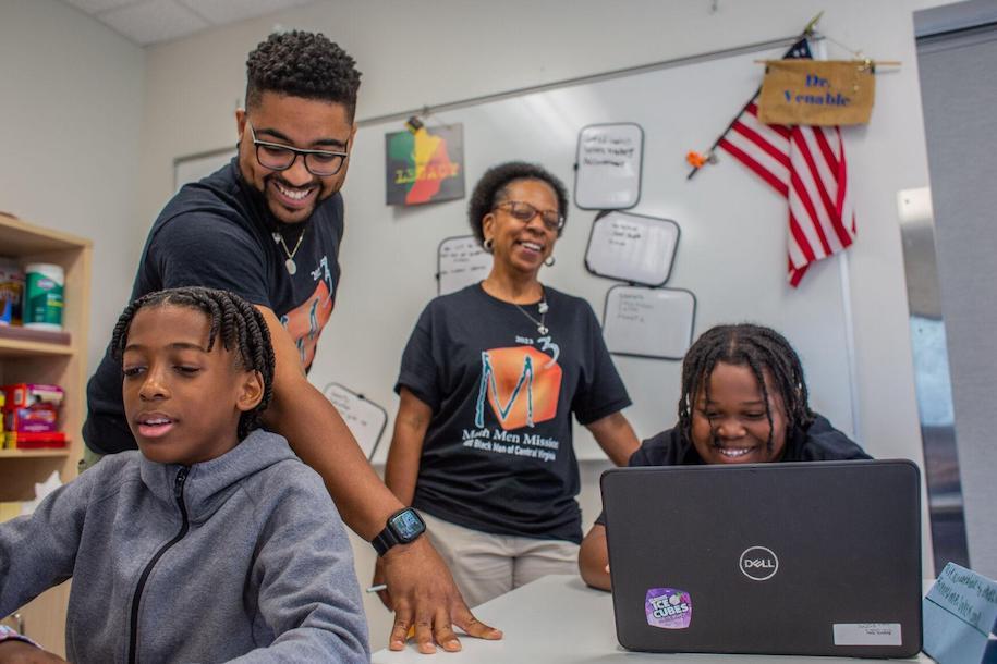Daniel Farley works with youth in a school classroom