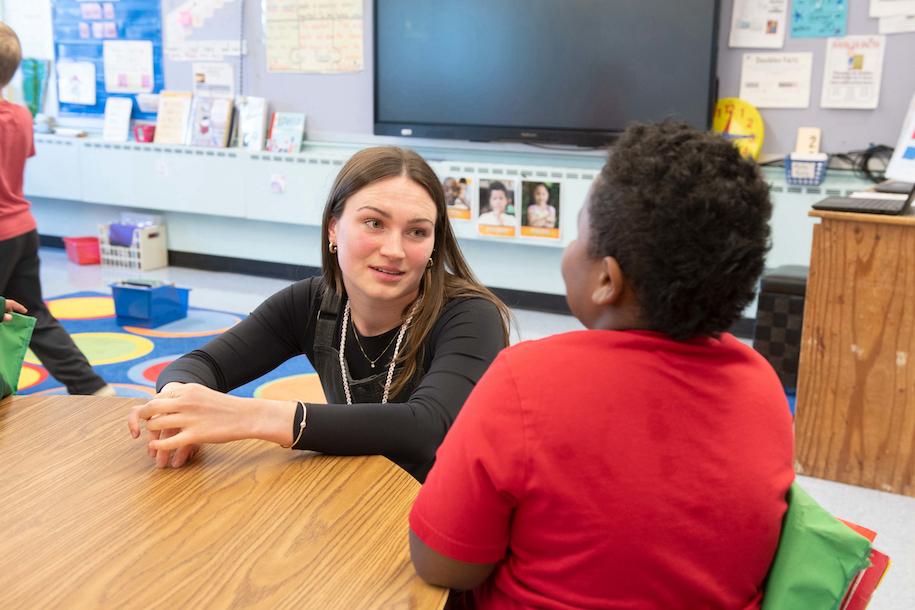 Ella McCarthy talking with a student at Essex Elementary School