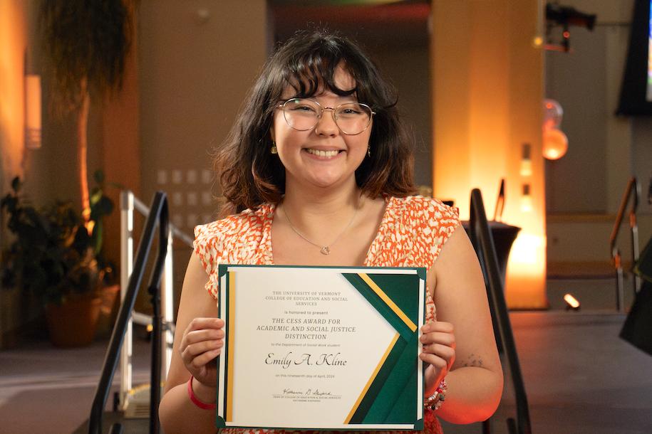 Emily Kline hold her award certificate at the Mosaic Center for Students of Color Awards Reception