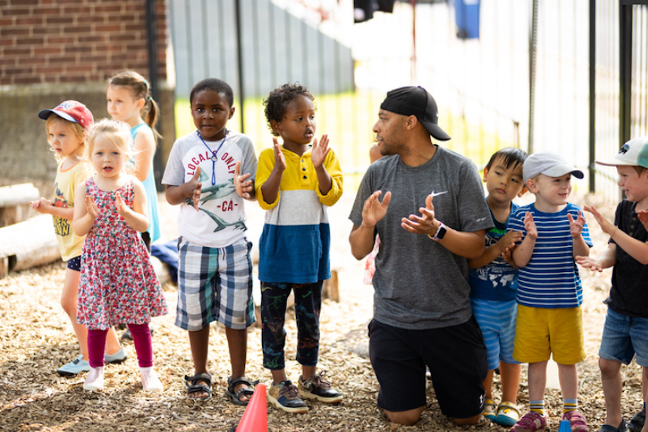 Early Childhood student leading outdoor activities with children