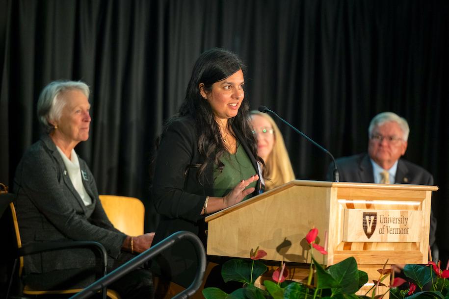 Aziza Malik speaking at the podium