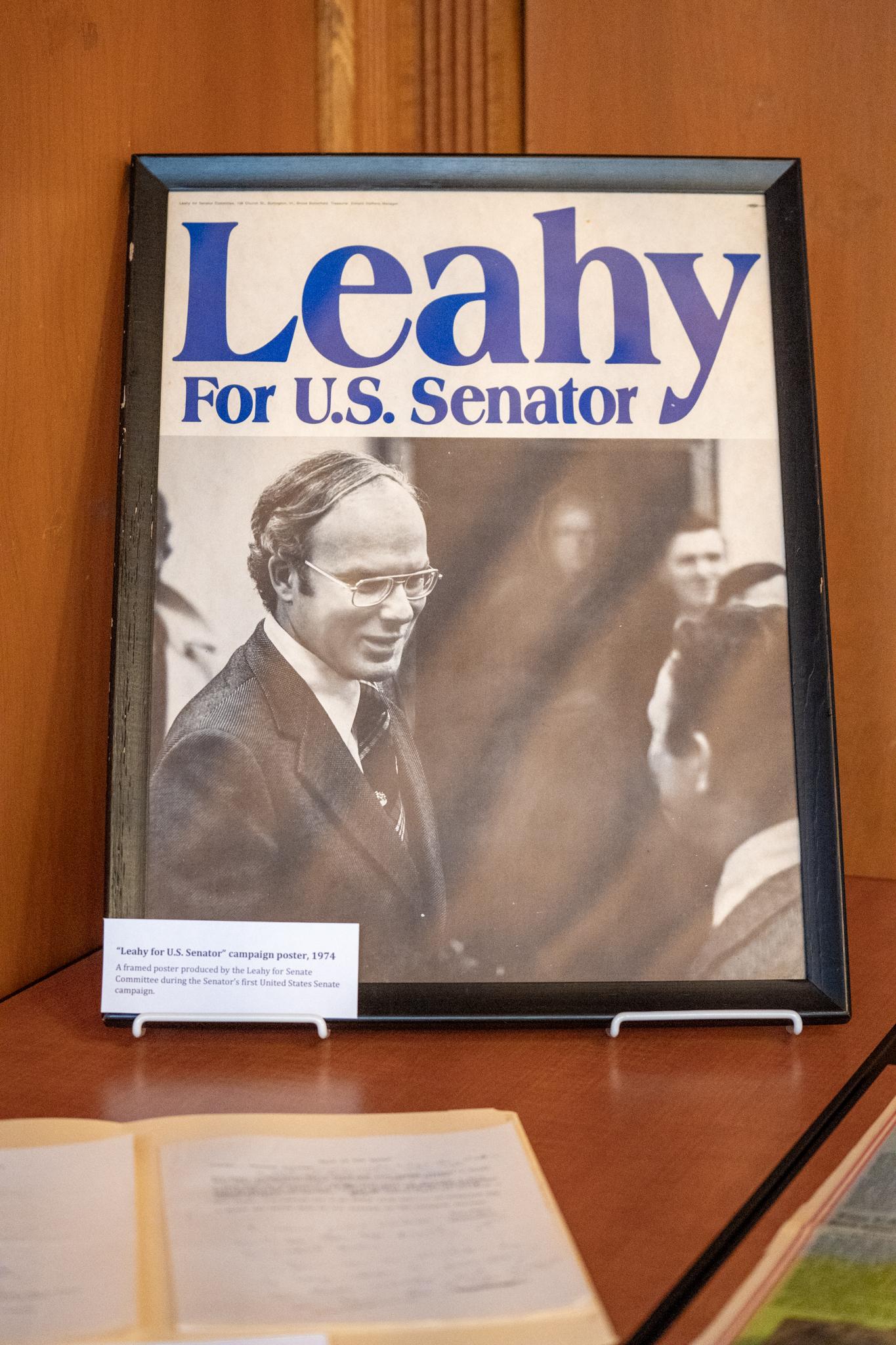 photograph from a UVM foundation event featuring a campaign poster of Patrick Leahy from 1974