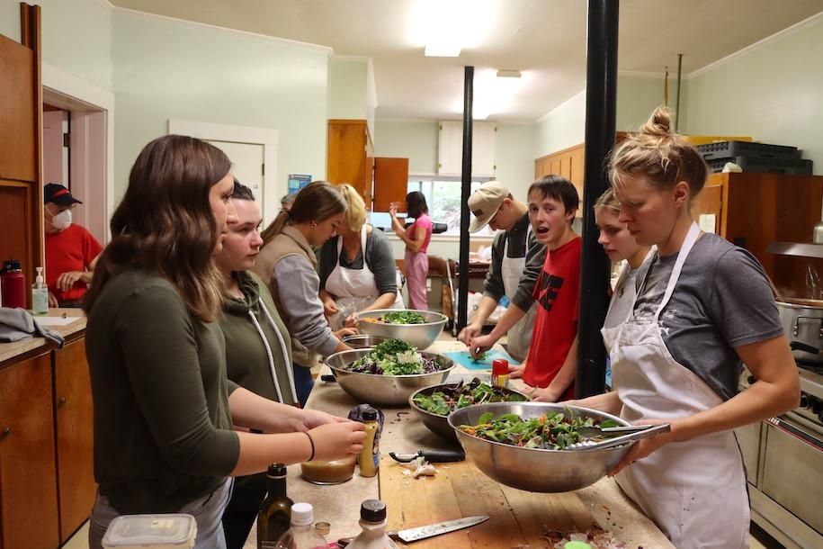 Reeve Basom, a community partner from the Center for an Agricultural Economy in Hardwick, working with students at the Hardwick Community Lunch.