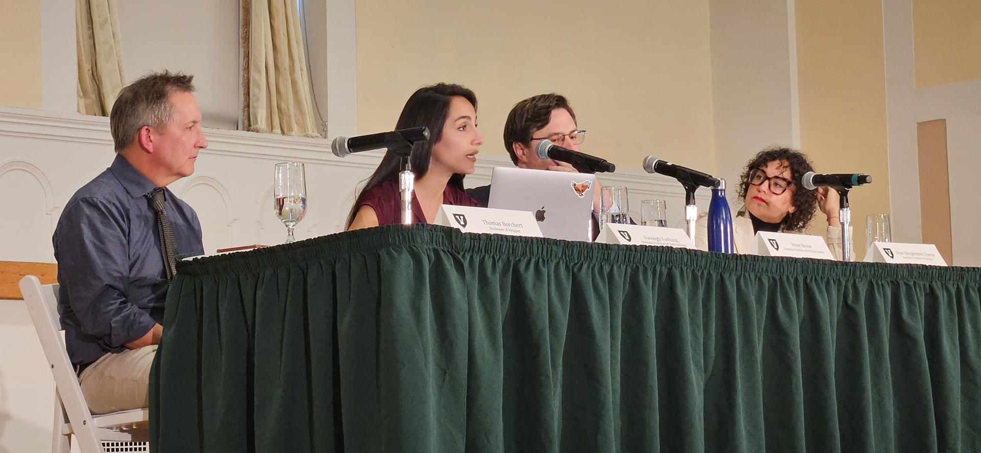 Four faculty members on panel discussion on the Ira Allen Chapel stage