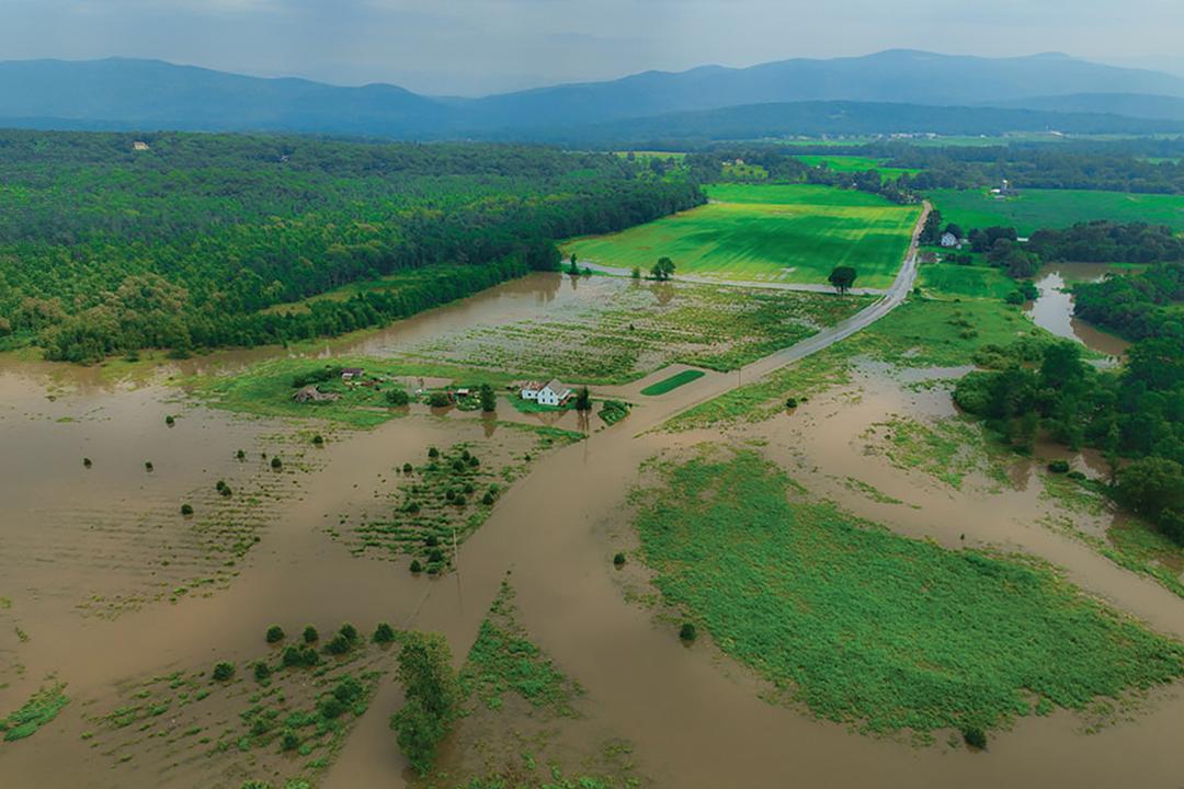 a vermont landscape with large open swaths of farmland flooded