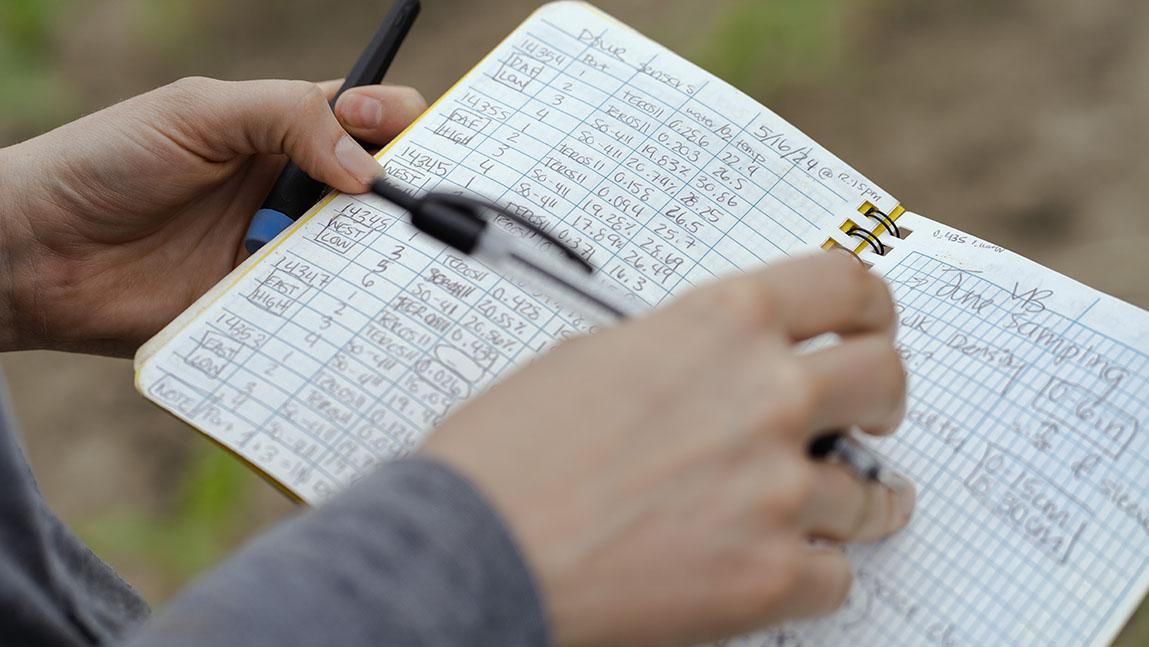 a notebook with handwritten data in it