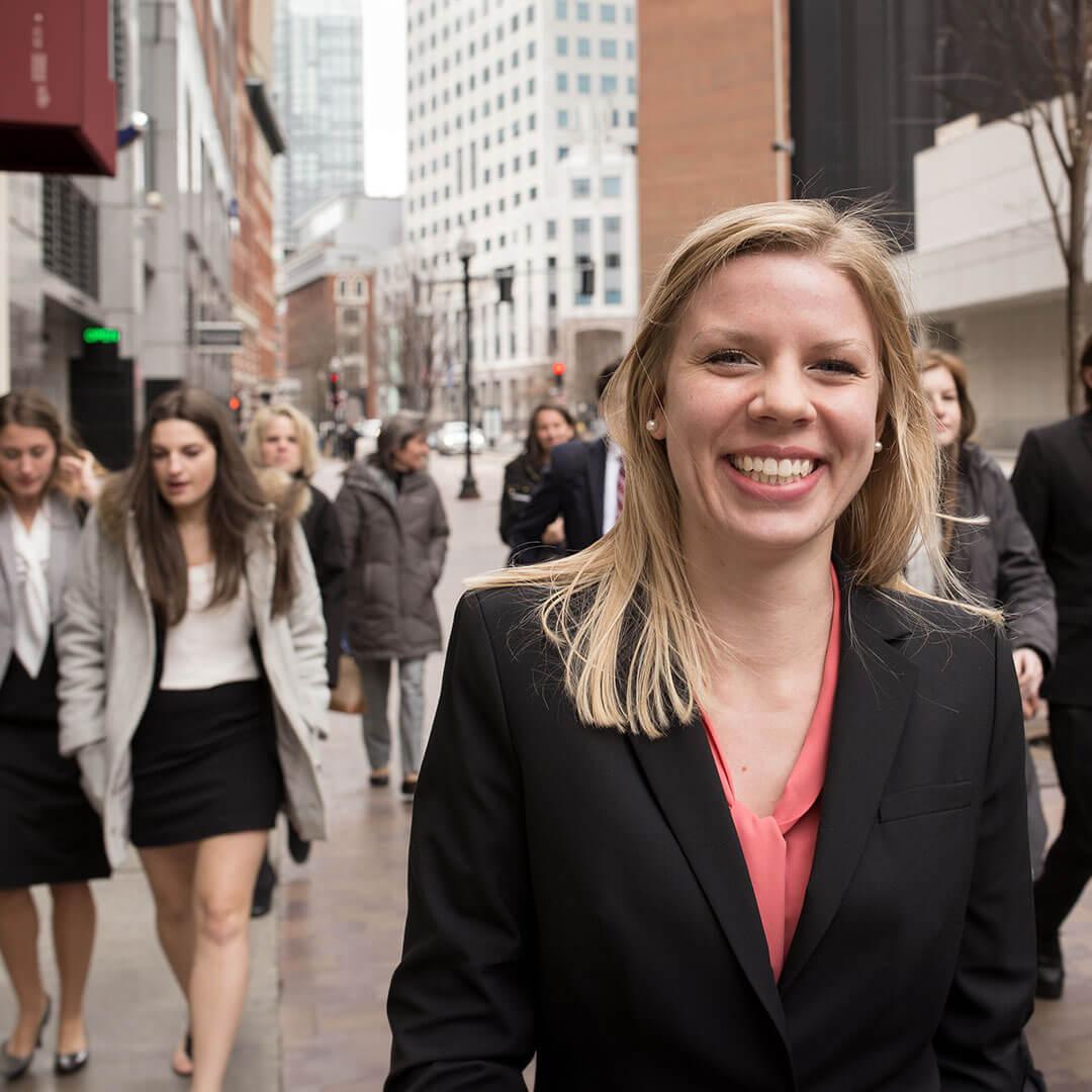 students walk toward the camera smiling