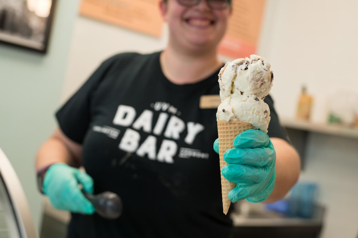 Person holding out an ice cream cone