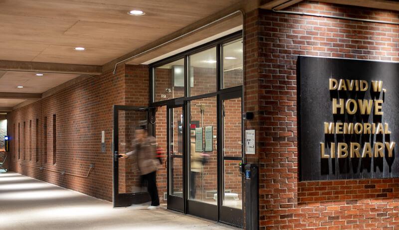 A student exits the Howe Library.