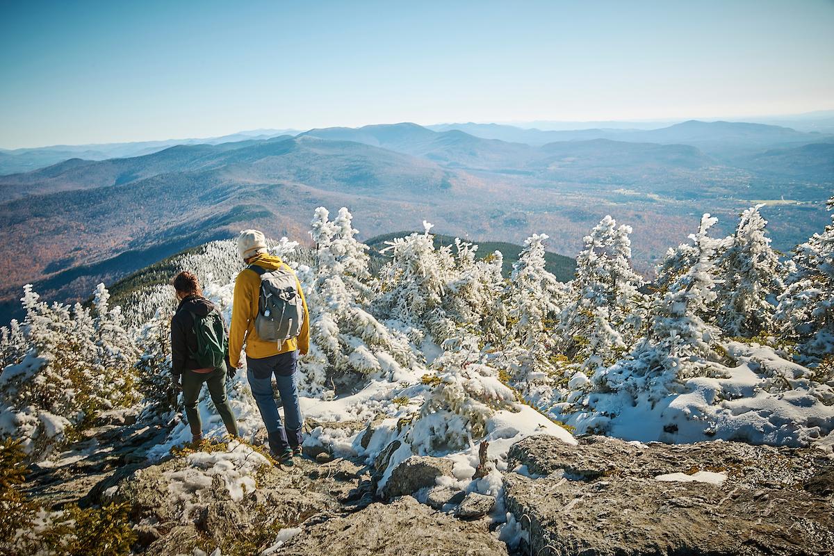 People stand on a snowy mountain summit