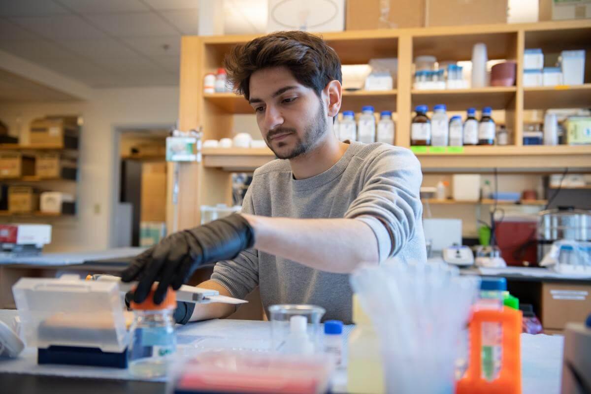 A student uses a pipette in a lab