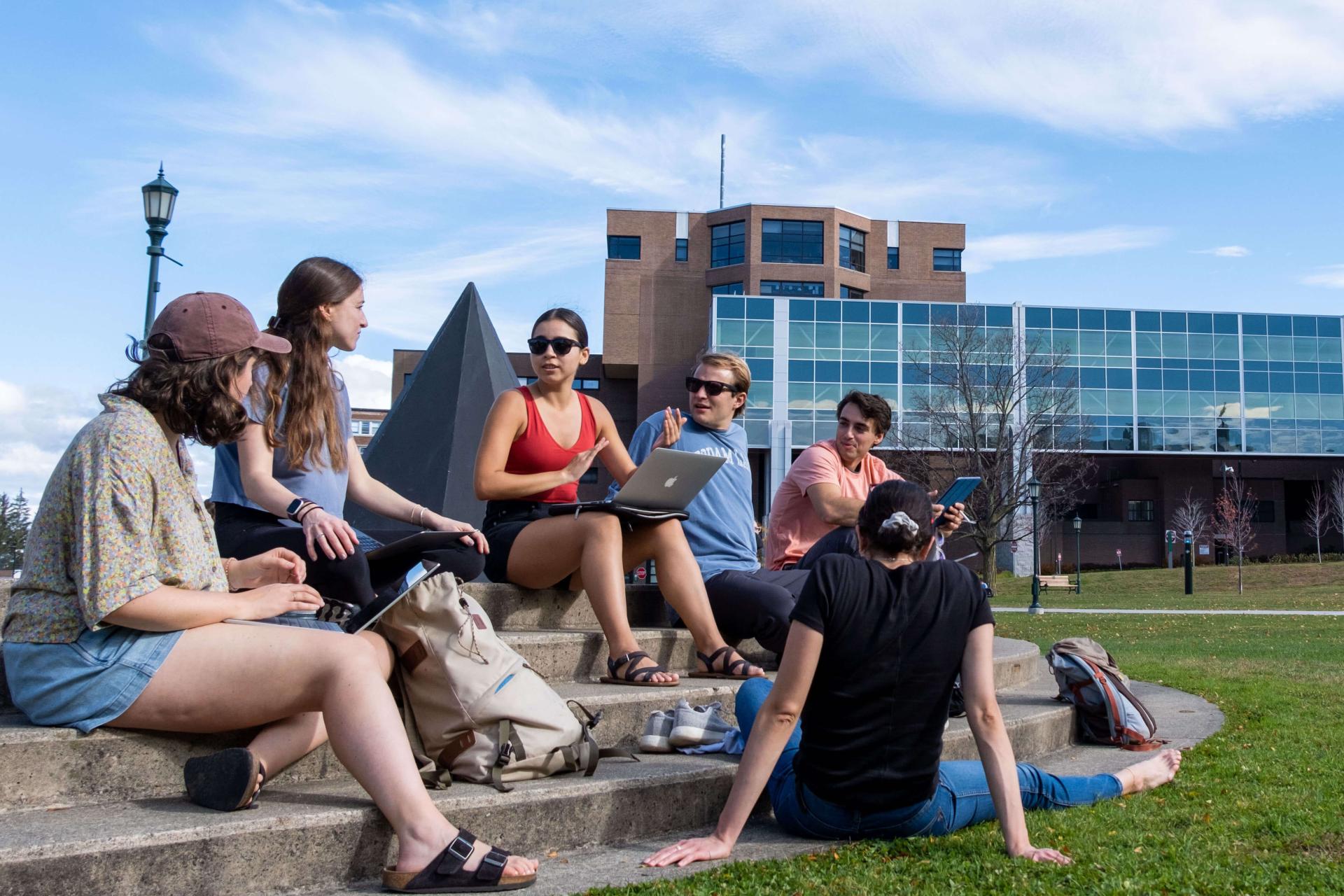 Students meeting outside on steps