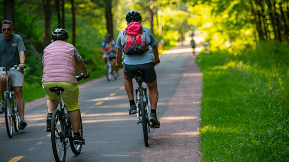 People ride bikes on the bike path