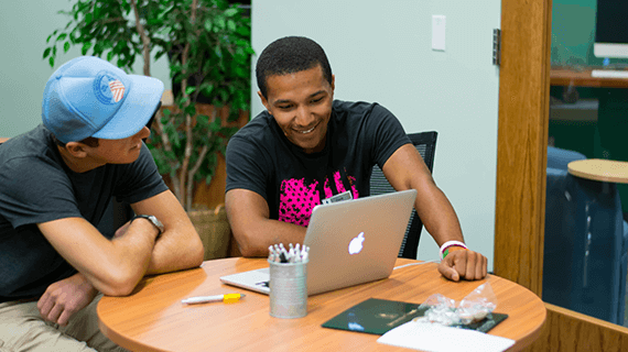Two students studying together at a table