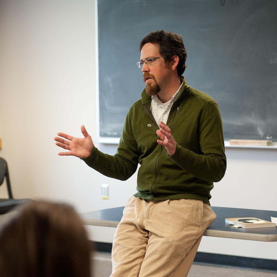 A professor addresses a class.