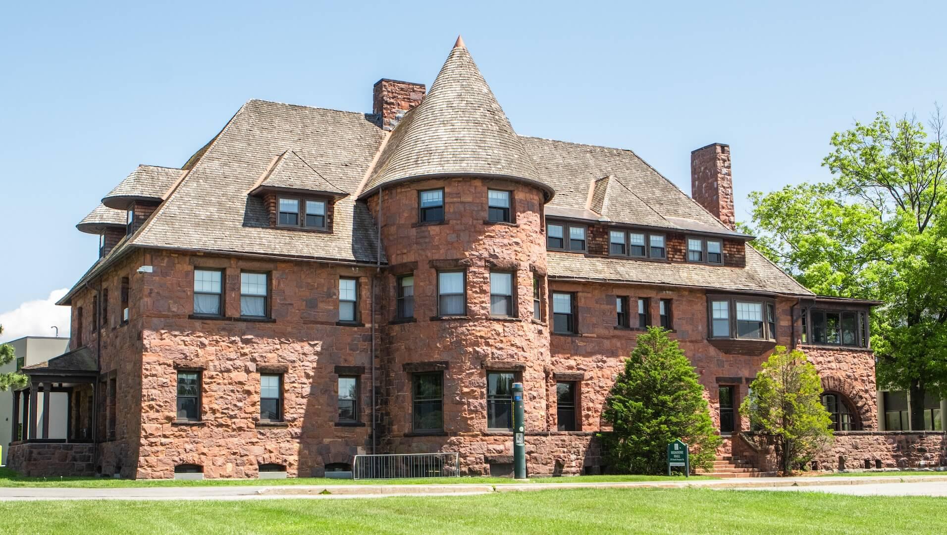 A historic brick building with a round turret.