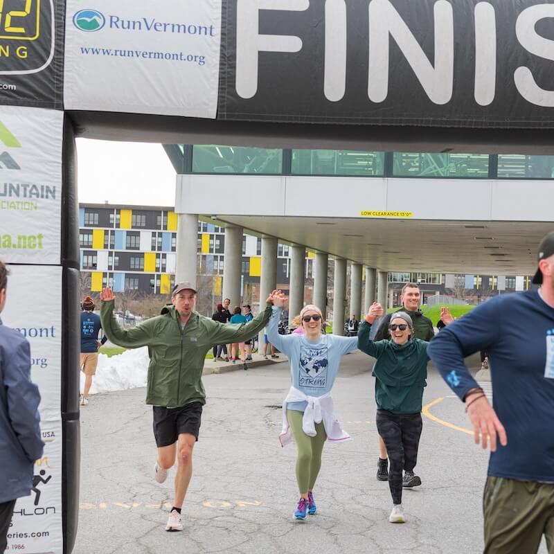 Students running across a finish line.