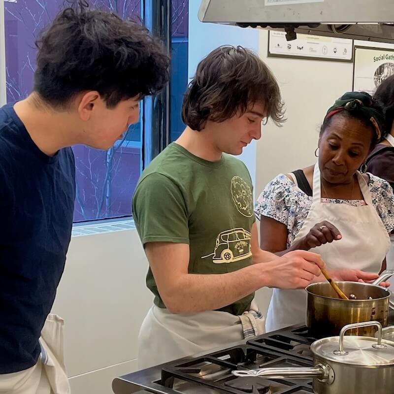 Students cooking with a local chef giving instruction. 