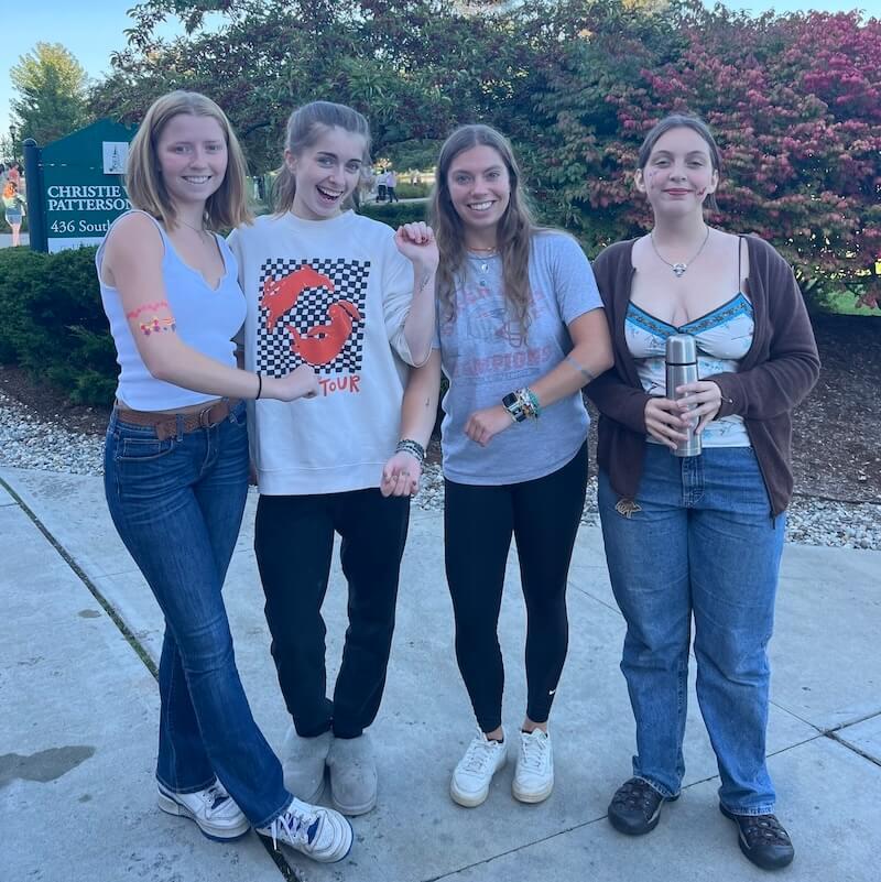 Students showing off face and arm paint. 