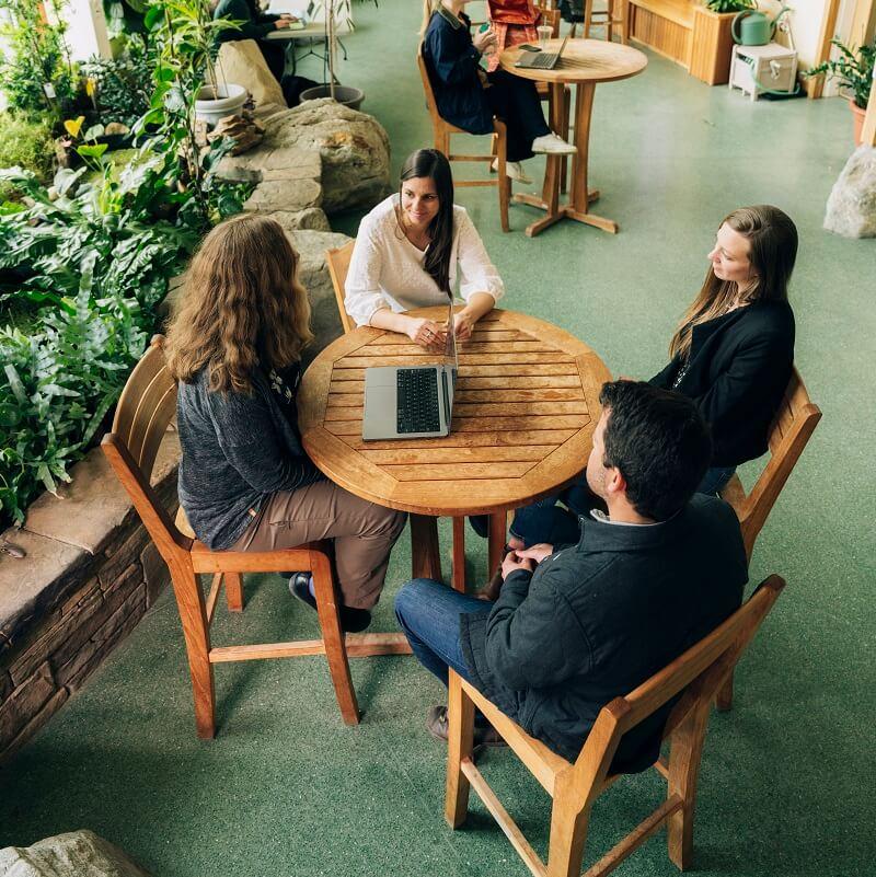 A group of faculty sitting around a table talking