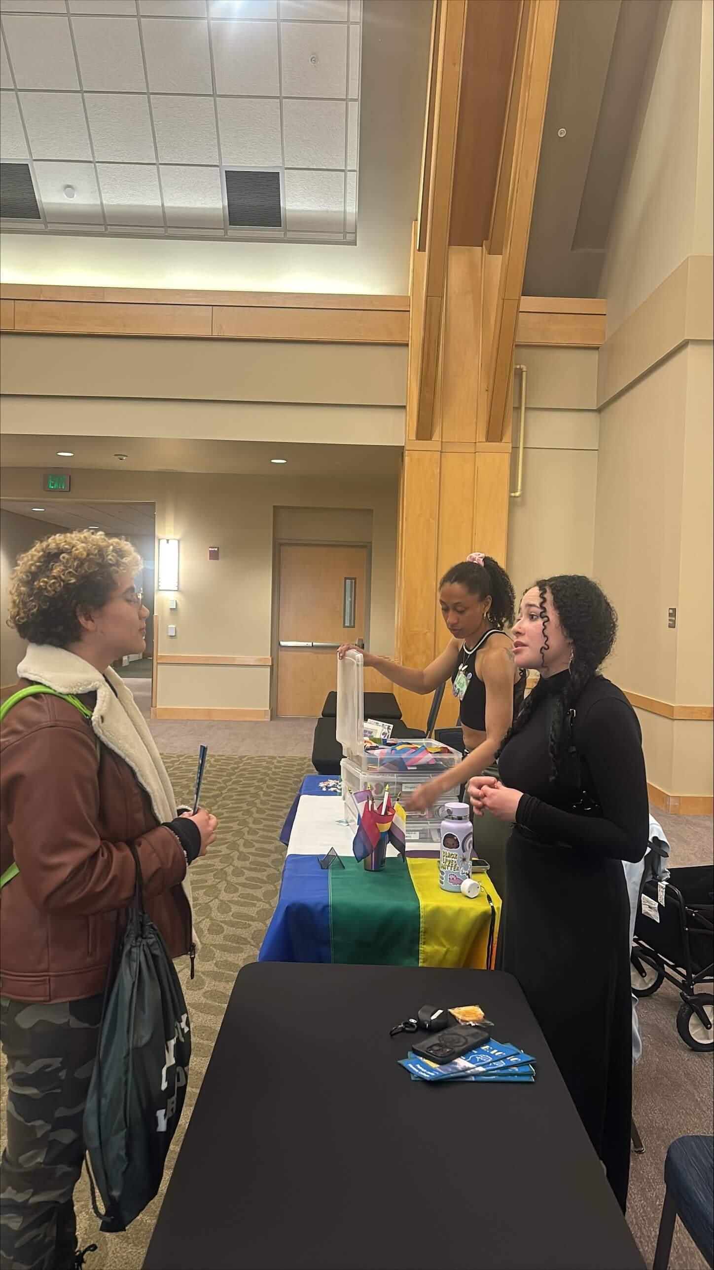two students speaking at a tabling event