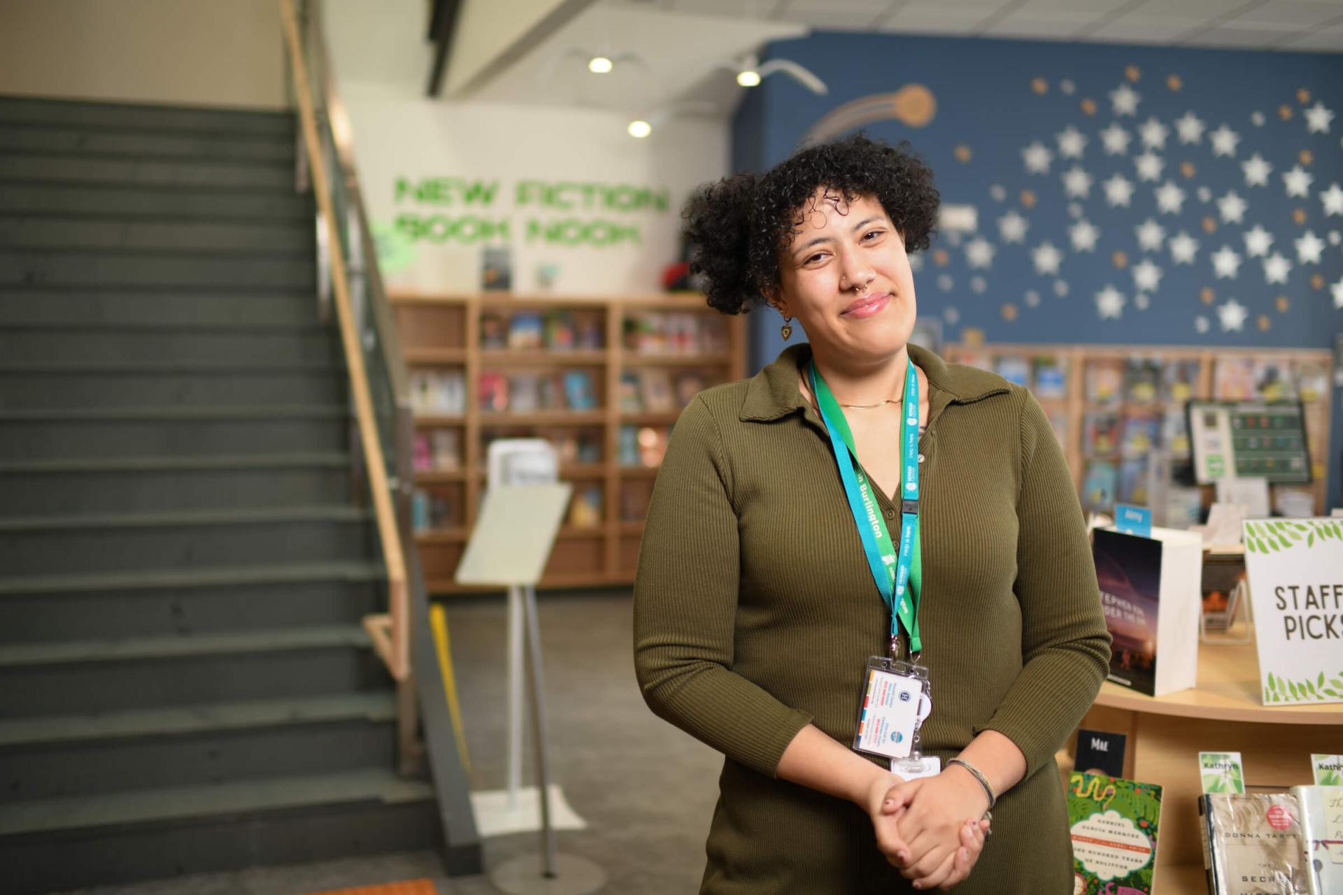 Evelyn Monje smiles int he library