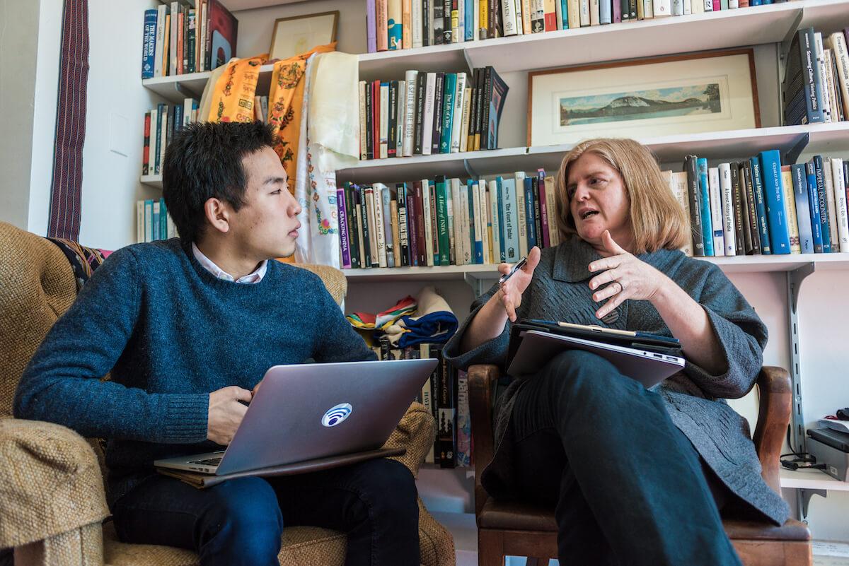 A student and professor talk together in the professor's office