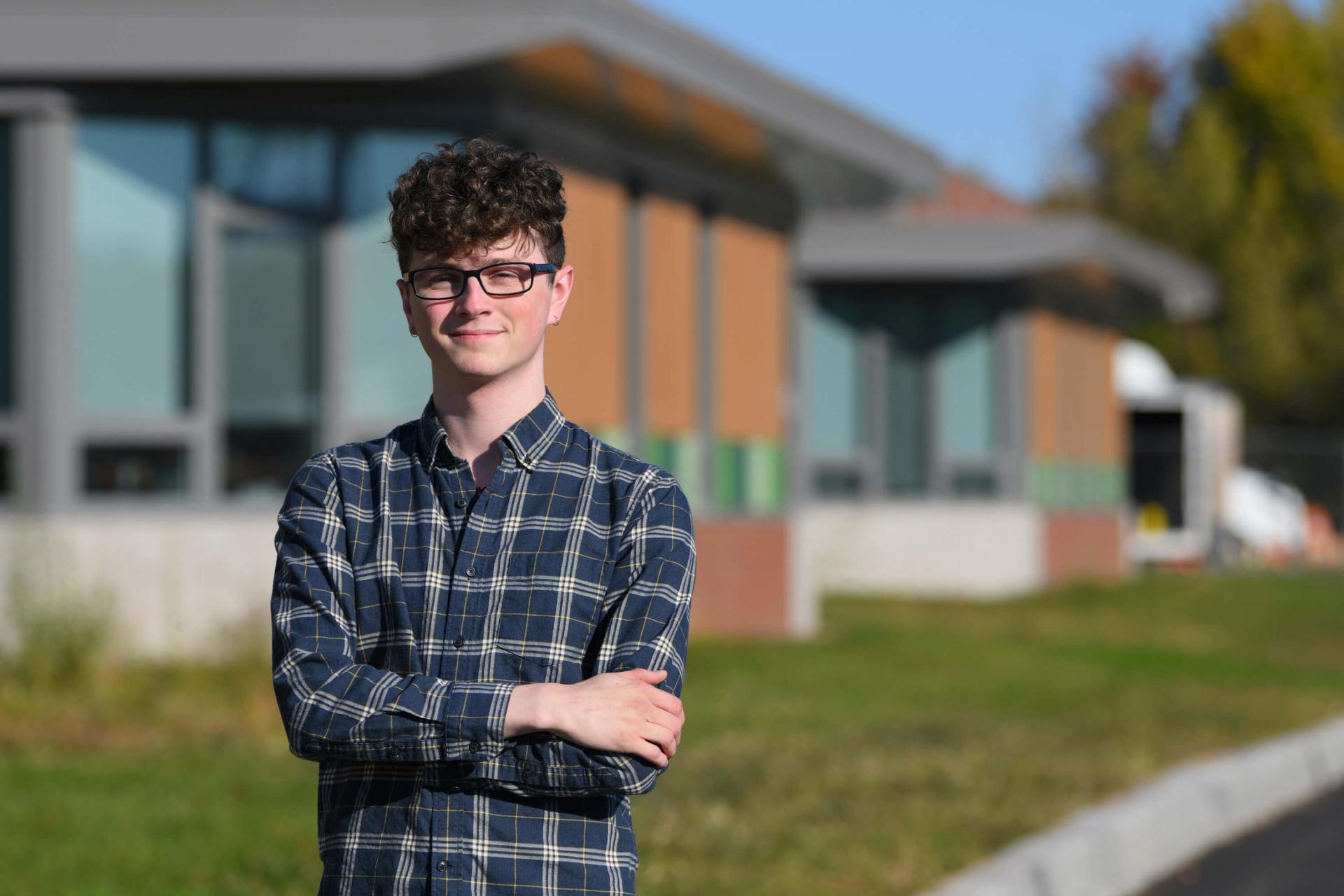 Alden Ducharme in front of Winooski Middle School