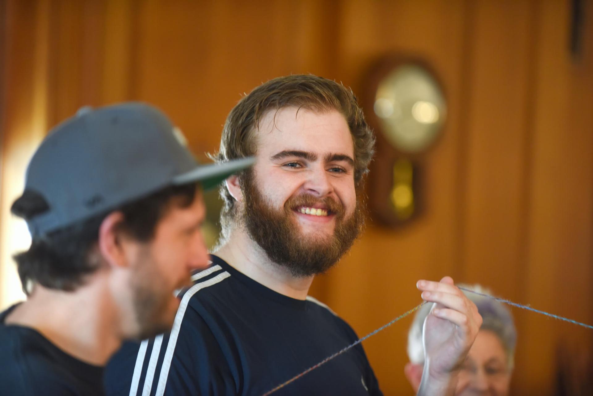 Student smiles during a group activity with his social work (BSW) cohort.
