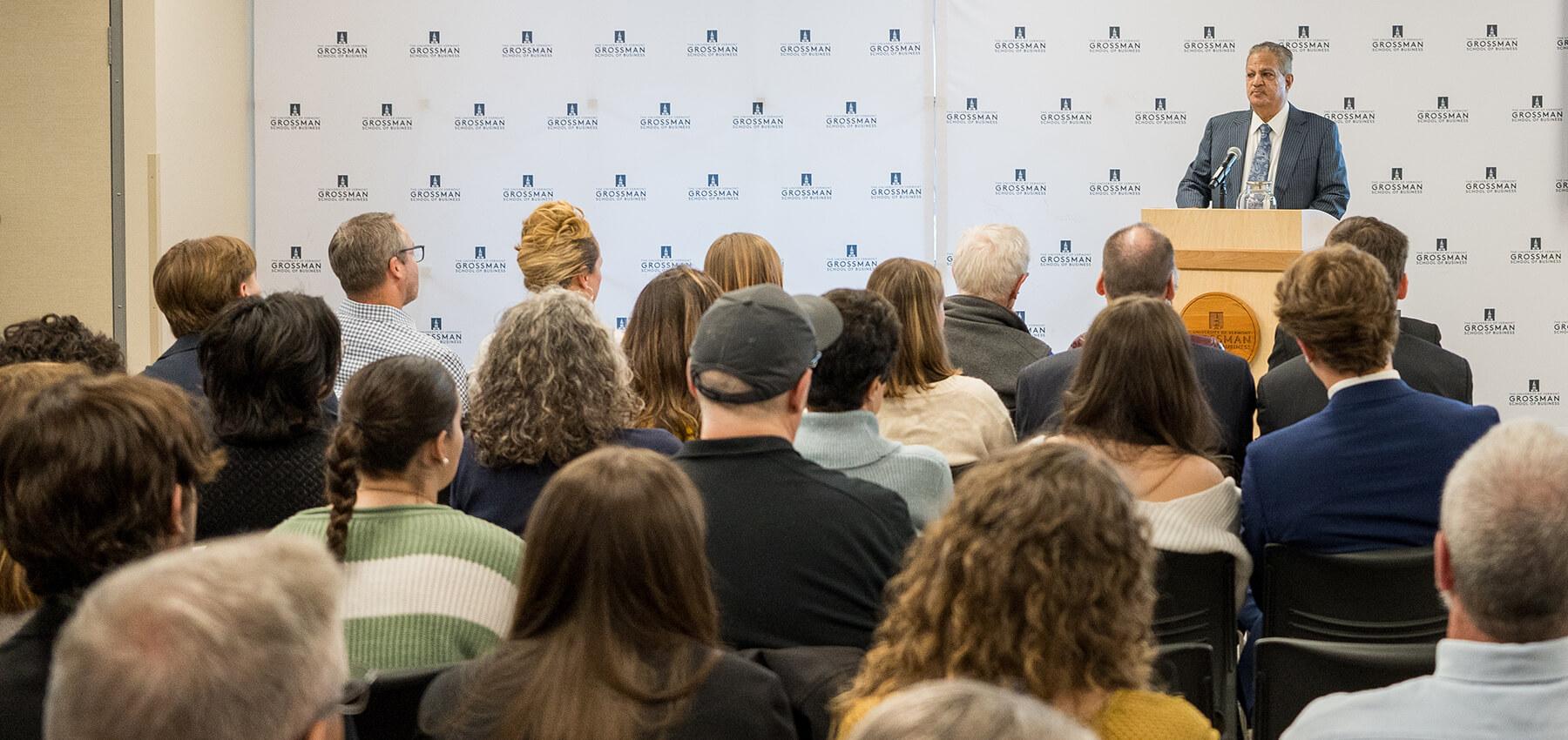 Dean Sharma addresses students on Honors Day