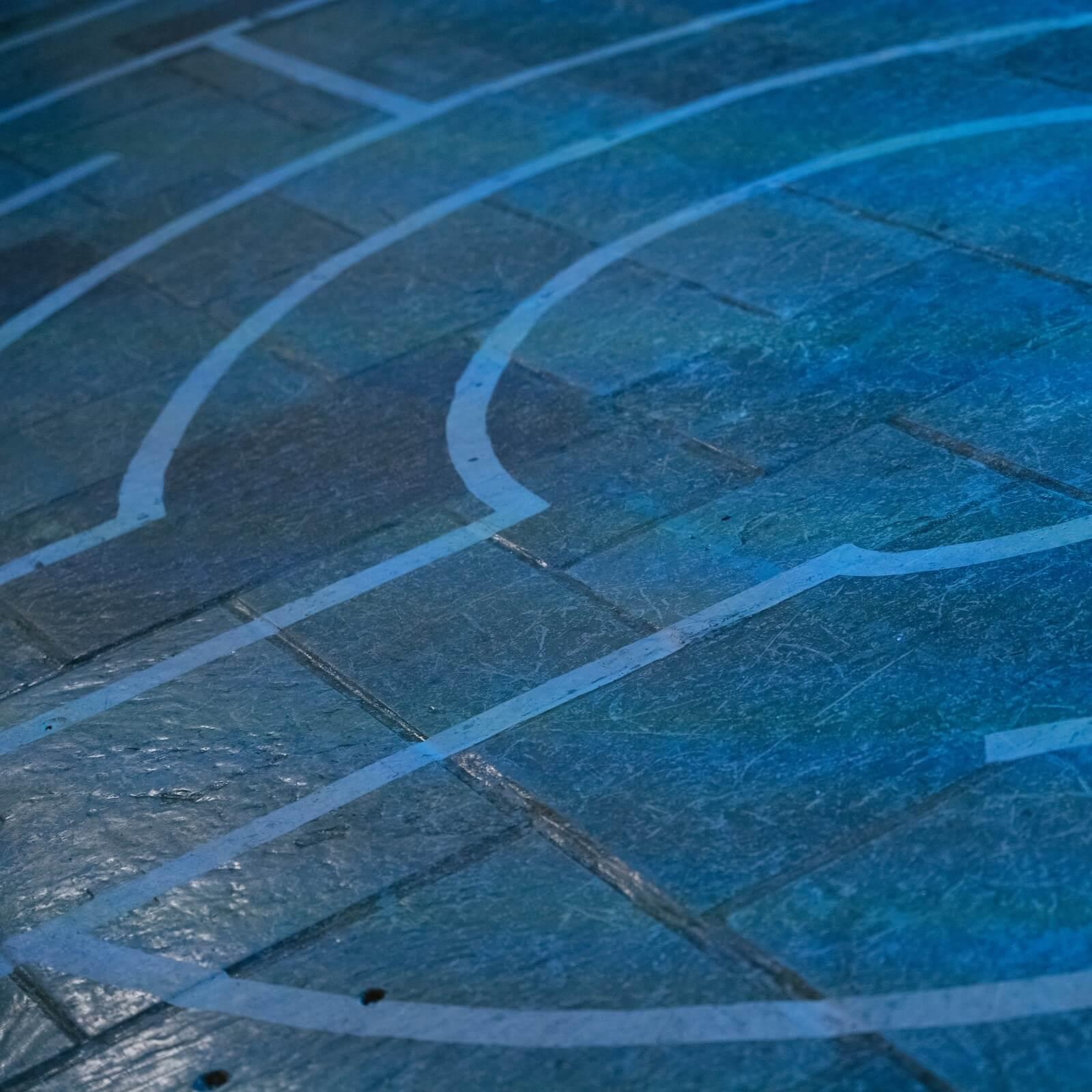 Segment of a labyrinth painted onto a tile floor of the Interfaith Center