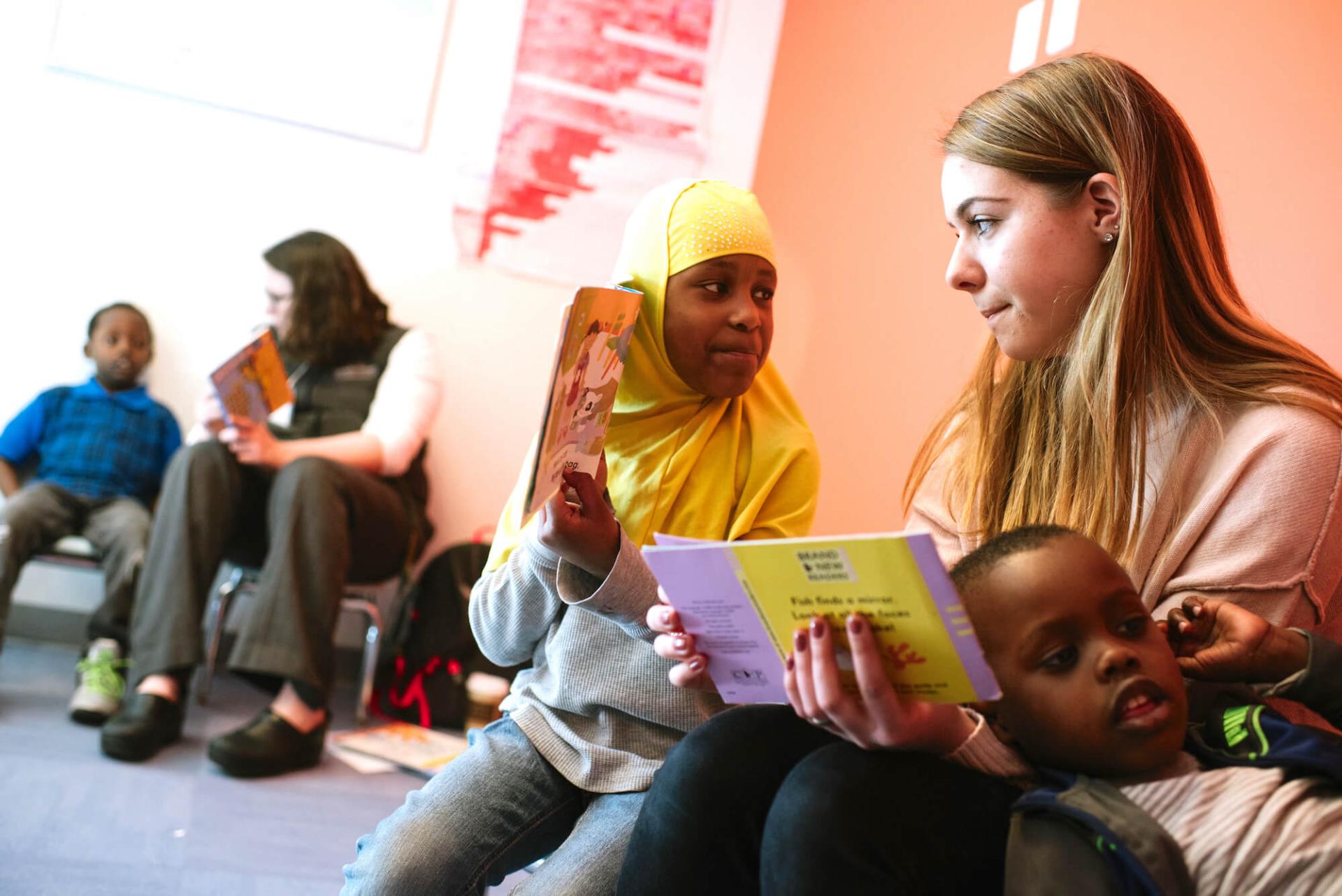 Student engages with young children at the King Street Center in Burlington.