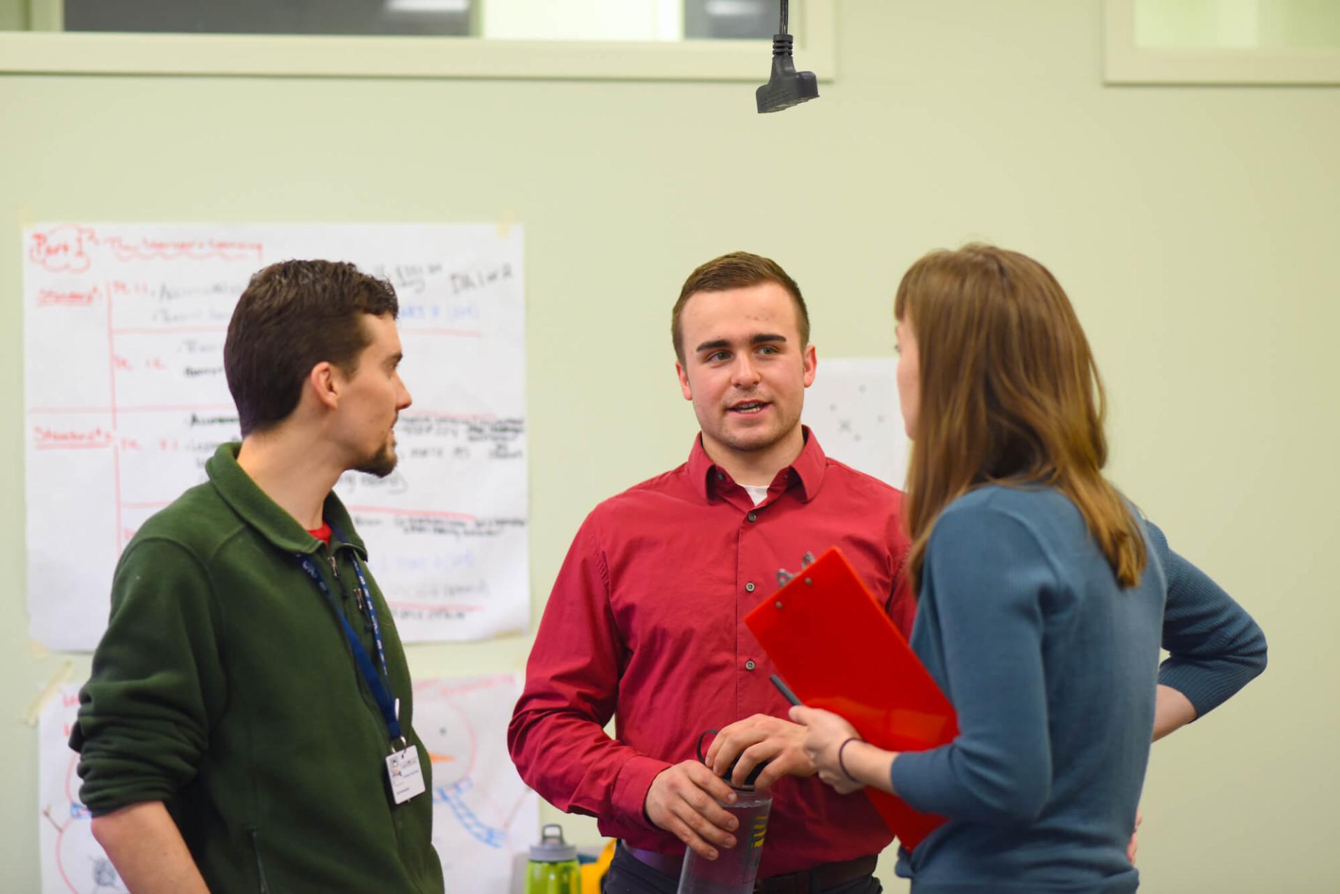 MAT students and faculty engaging in conversation.