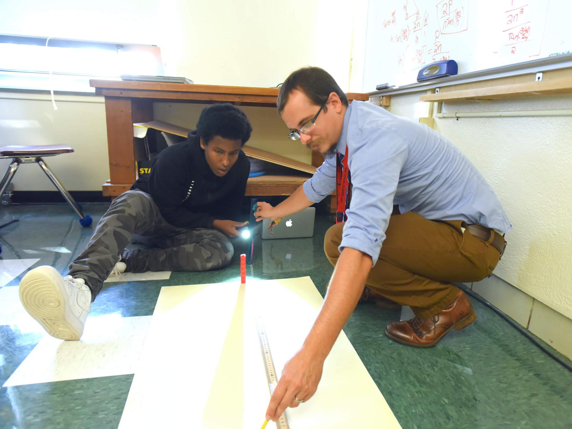 Vermont Teacher of the Year Tom Payeur works with a student on a hand-on activity at Winooski High School.