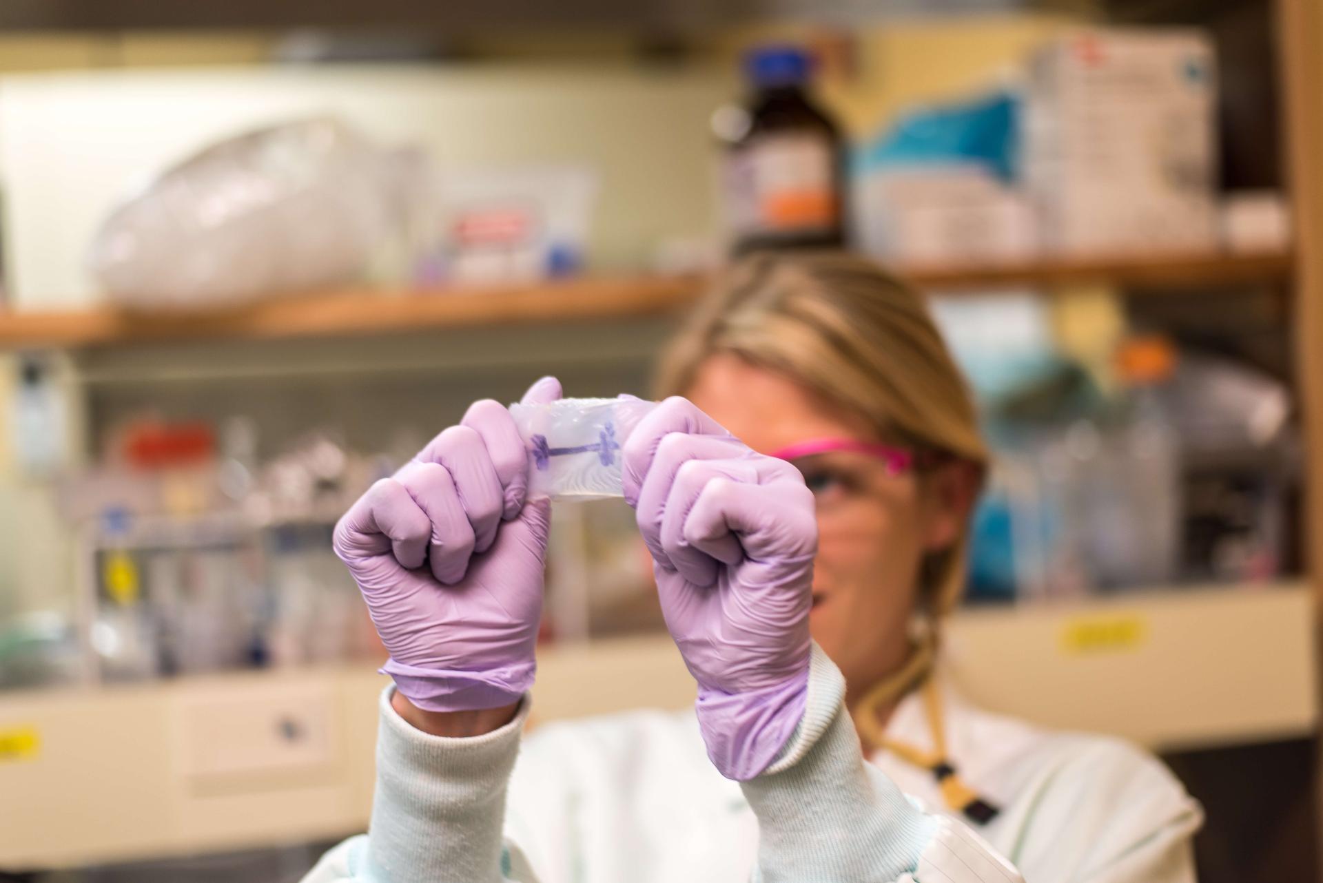 women holding up biomedical engineering part