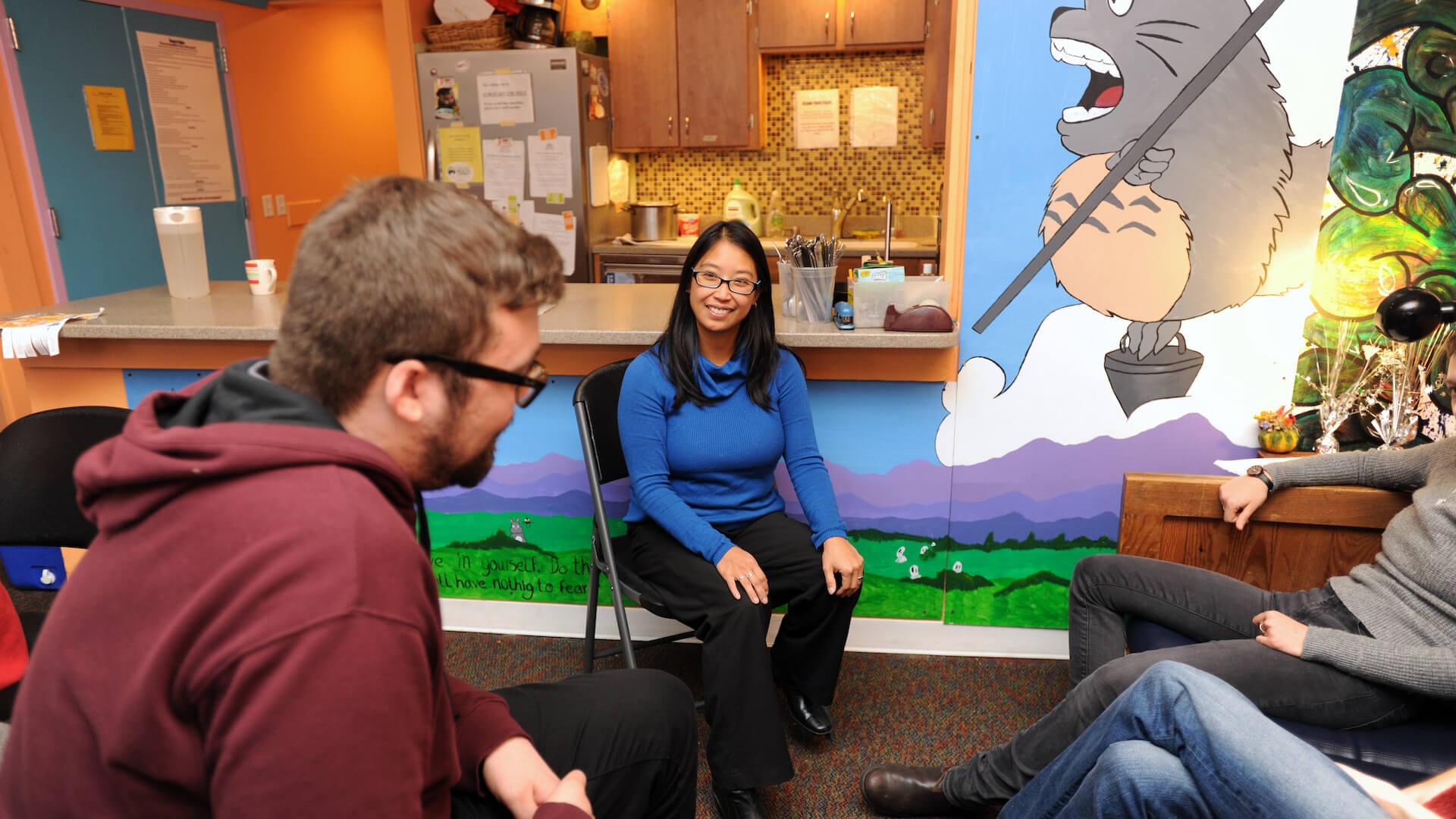 Social Work professionals and and interns conversing with each other at Spectrum Youth and Family Services
