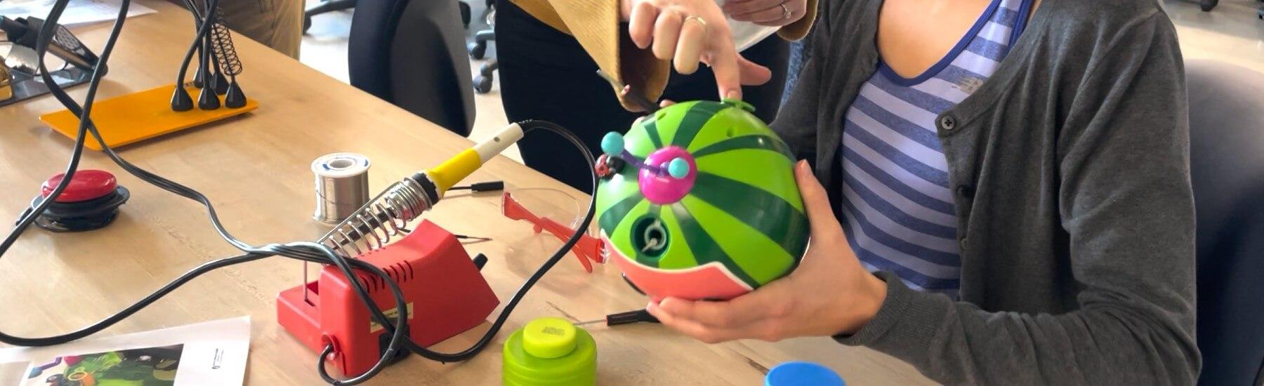 UVM occupational therapy student adapts a toy in the lab for a young client