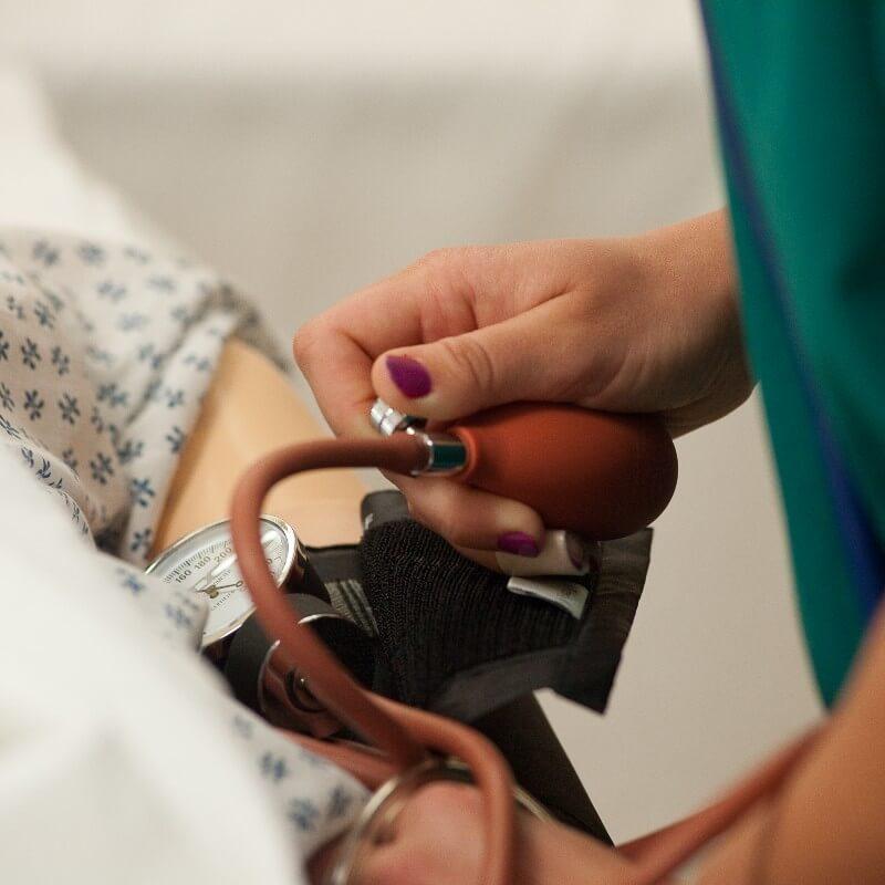 Student nurse taking blood pressure