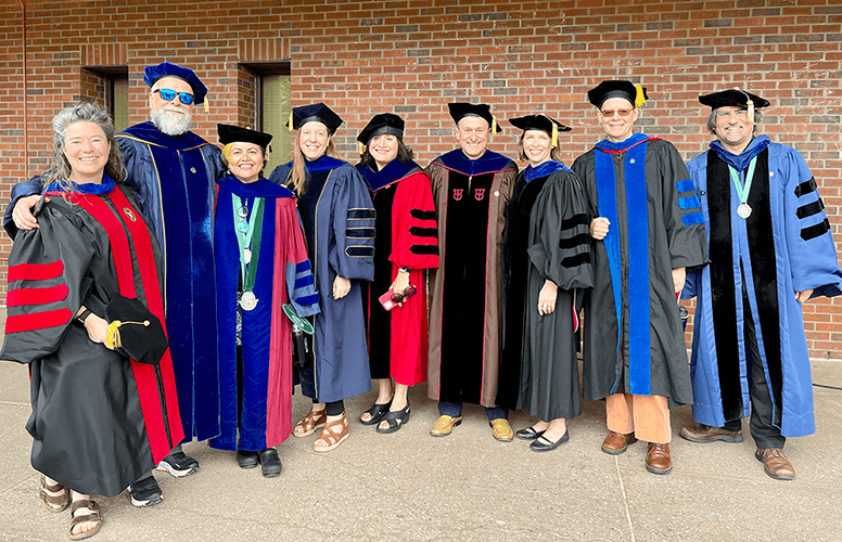 Group of people in graduation robes and caps