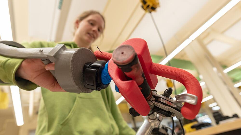 Students test their design concept of a prosthetic device to assist bike riders