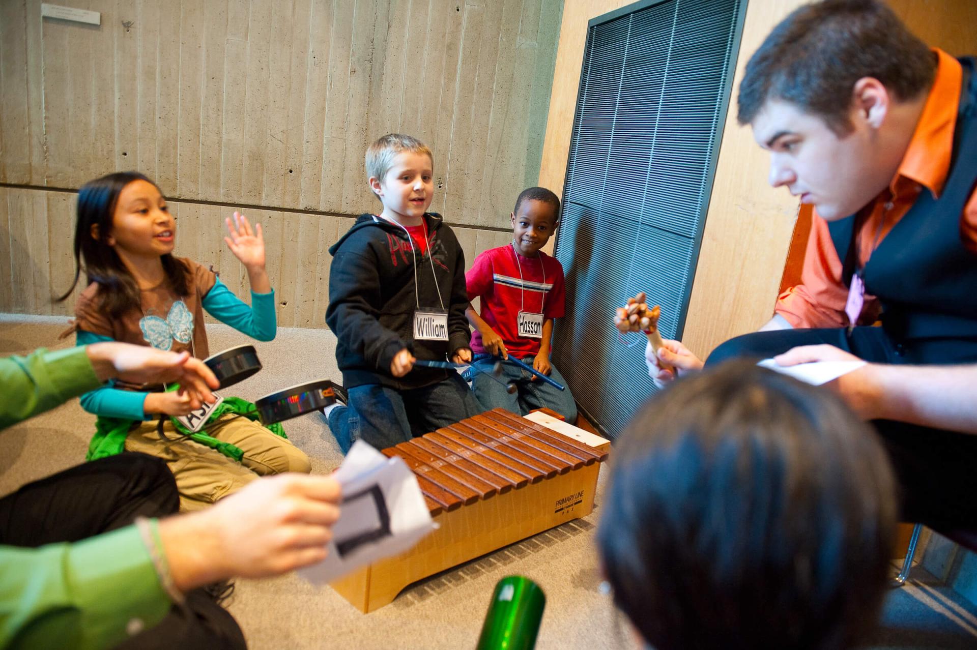 Music teacher leads a group of students at local school.