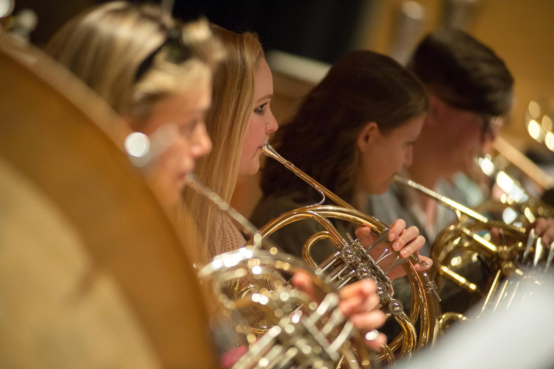 Students in horn section performing in a band.