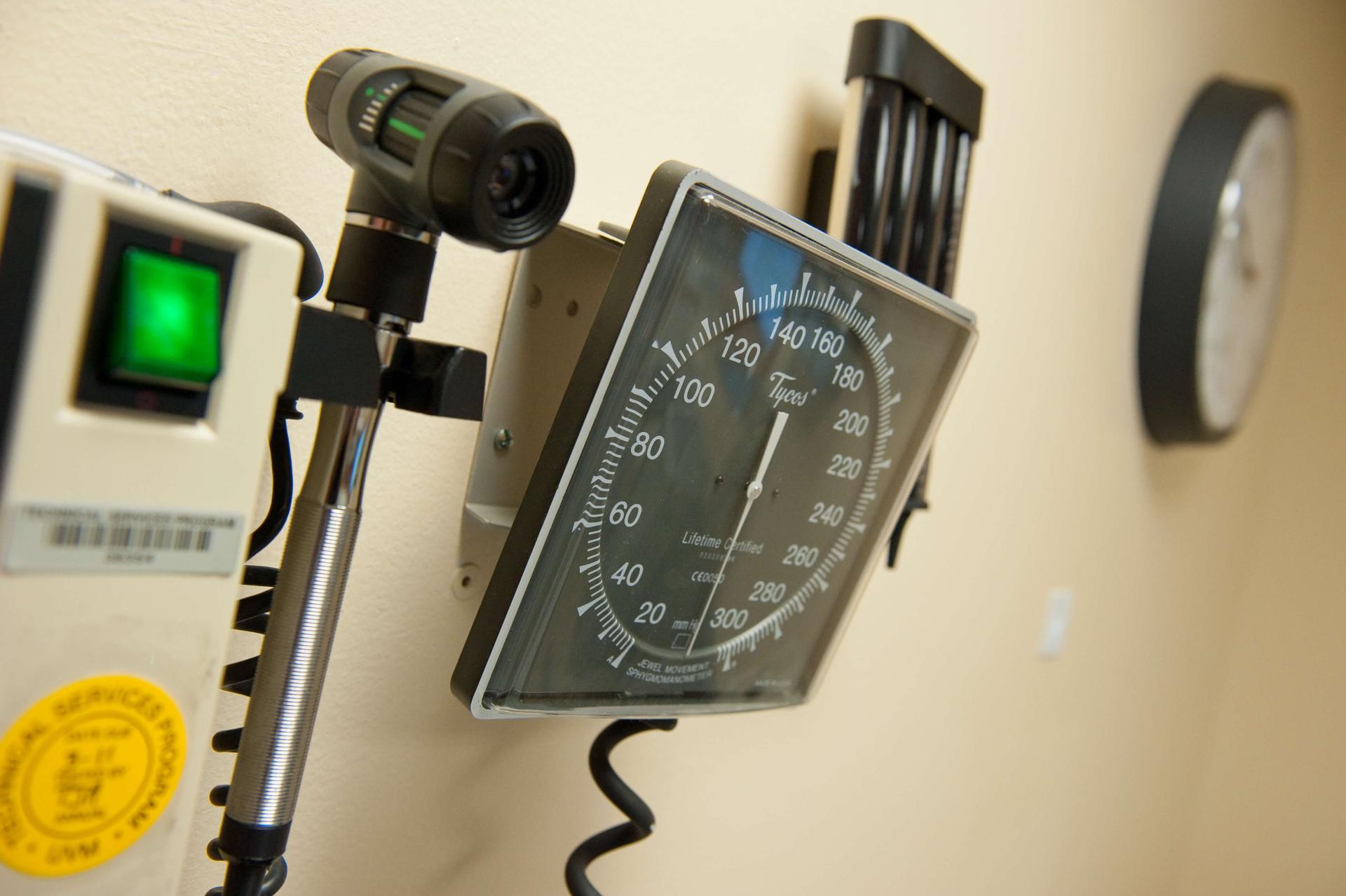 Blood pressure monitor hanging on wall in clinic